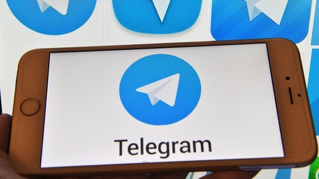 Telegram messenger logo on a computer and a smartphone © Natalia Seliverstova