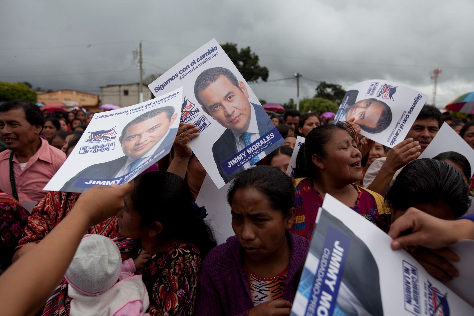 Campaign posters featuring presidential candidate Jimmy Morales of the National Front of Convergence party, are passed out during a rally, in Chichicastenango, Guatemala, Saturday, Oct. 17, 2015. Voters will head to the polls on Oct. 25 to choose a new leader in the presidential run-off. (AP Photo/Moises Castillo)