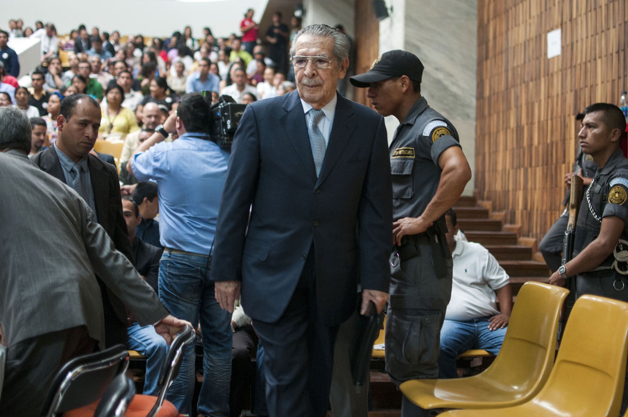 Guatemala's former dictator General Efraín Ríos Montt enters the court after Tribunal President Yasmin Barrios announced that judges overseeing the trial will not accept another judge's ruling that the case should start over, one day after a judge ordered the suspension of the genocide trail against Rios Montt and General Jose Mauricio Rodriguez Sanchez in Guatemala City, Friday, April 19, 2013. Rios Montt seized power in a March 23, 1982 coup, and ruled until he himself was overthrown just over a year later. Prosecutors say that while in power he was aware of, and thus responsible for, the slaughter by subordinates of at least 1,771 Ixil Mayas in San Juan Cotzal, San Gaspar Chajul and Santa Maria Nebaj, towns in the Quiche department of Guatemala's western highlands. (AP Photo/Luis Soto)