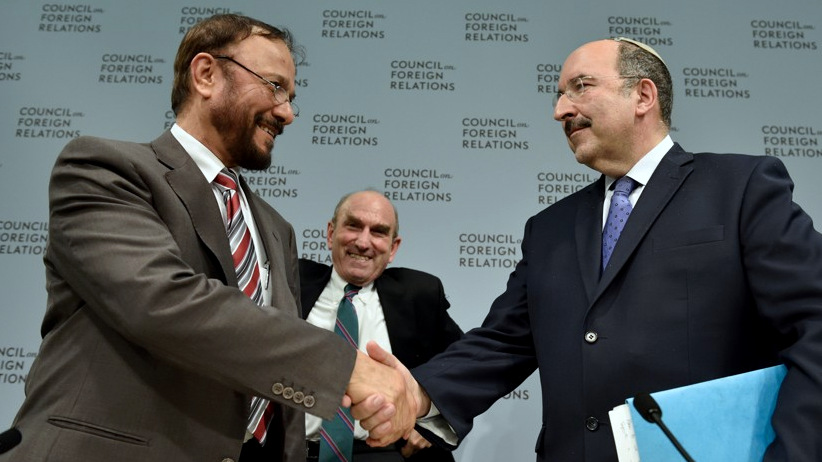Dore Gold and Anwar Eshki shake hands at a CFR event, as Elliott Abrams looks on.