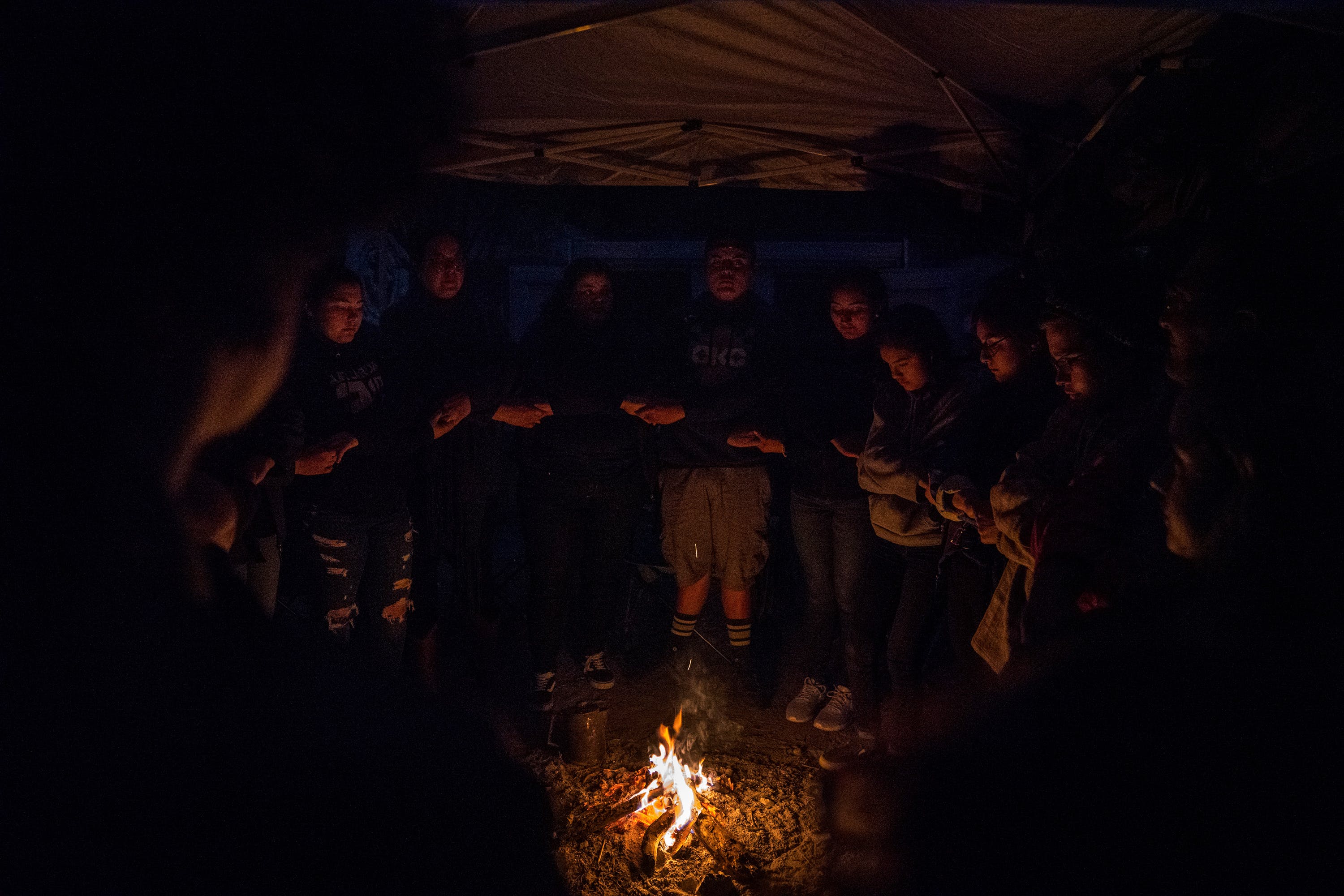 “Al Exito” members along with Carrizo/Comecrudo Tribe members, and activists gather around the fire to share things that they are thankful for at Yalui Village in Hidalgo County, Texas on March 17, 2019.Photo: Verónica G. Cárdenas for The Intercept