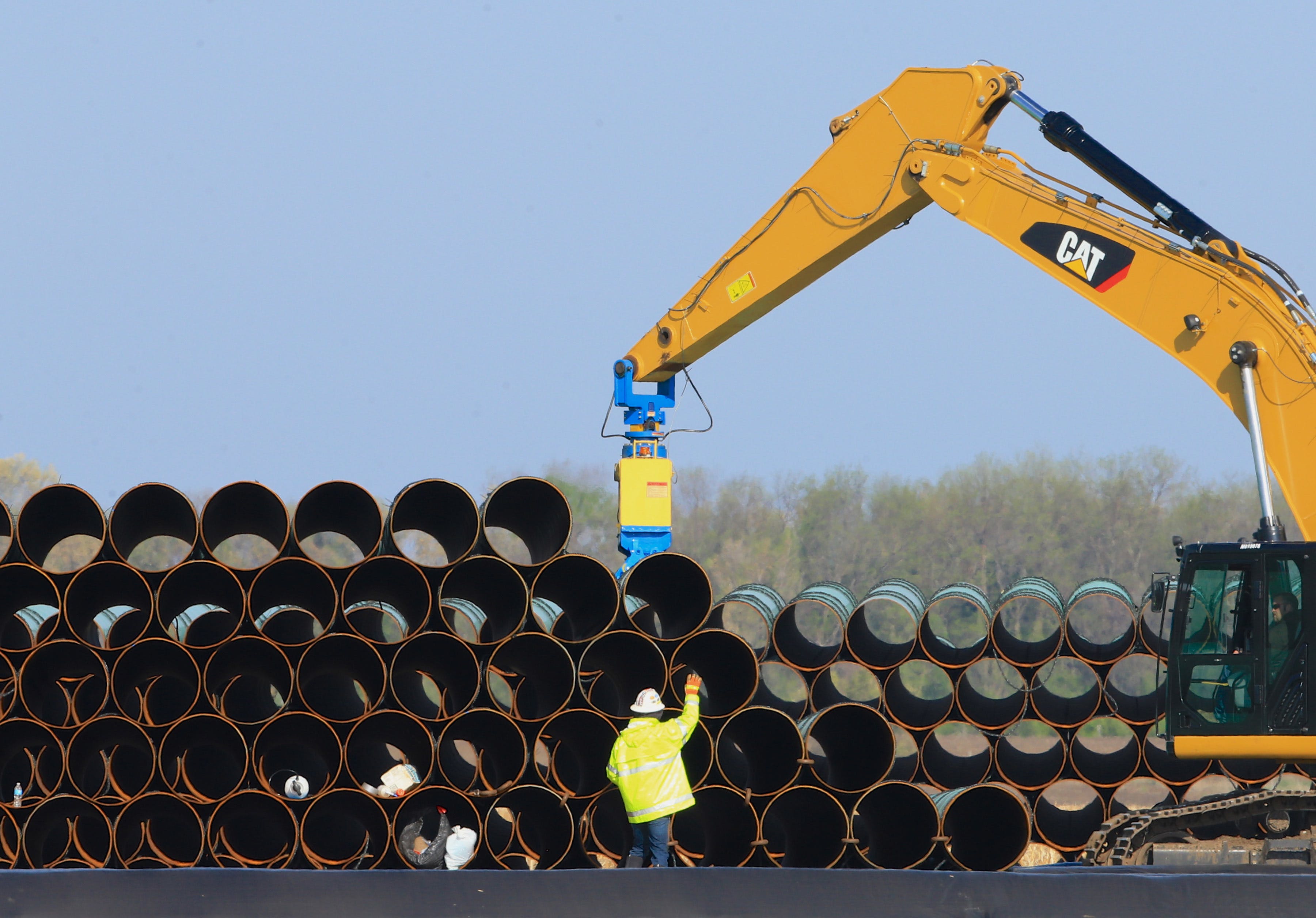 FILE - In this May 9, 2015 file photo, pipes for the proposed Dakota Access oil pipeline that will stretch from the Bakken oil fields in North Dakota to Illinois are stacked at a staging area in Worthing, S.D. Construction on the pipeline is now underway in North Dakota, South Dakota and Illinois, three of the four states that will carry the oil from western North Dakota. The pipeline also will cross Iowa, but regulators there have declined to act quickly on a request to allow Texas-based Energy Transfer Partners to begin construction in that state. (AP Photo/Nati Harnik, File)