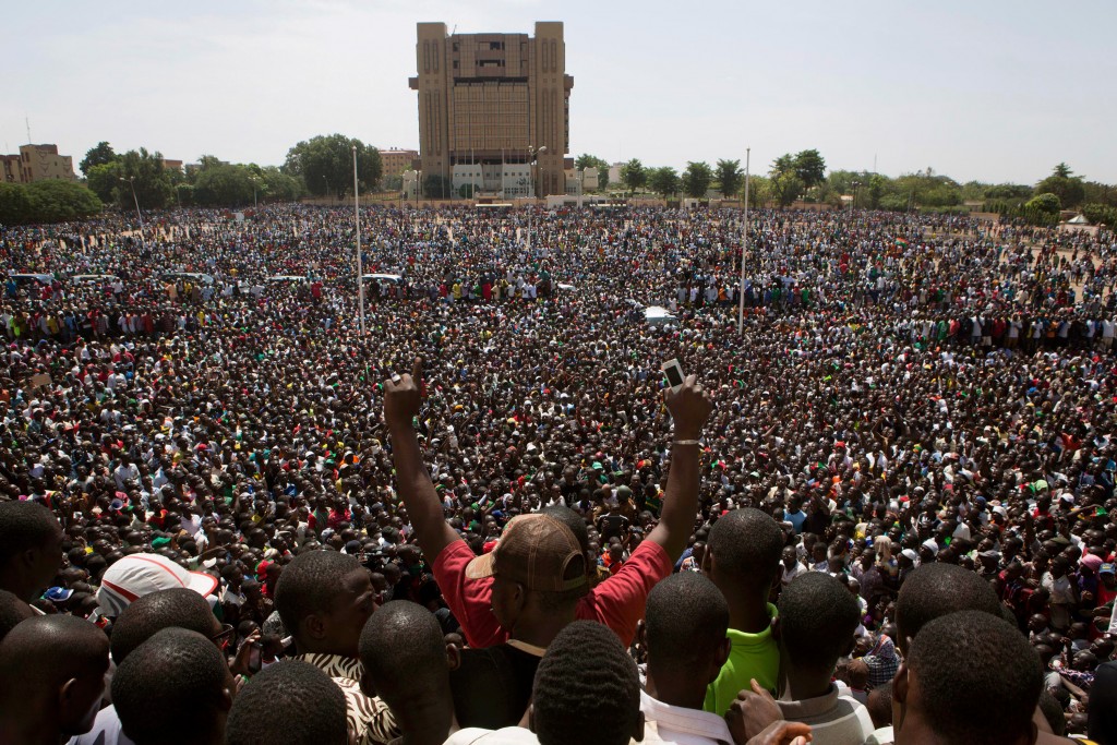 Anti-government protesters gather in the Place de la Nation in Ouagadougou, capital of Burkina Faso, October 31, 2014. General Honore Traore, the head of Burkina Faso's armed forces, took power on Friday after President Blaise Compaore resigned amid mass demonstrations against an attempt to extend his 27-year rule in the West African country. REUTERS/Joe Penney (BURKINA FASO - Tags: POLITICS CIVIL UNREST TPX IMAGES OF THE DAY) - GM1EAAV1SCI01
